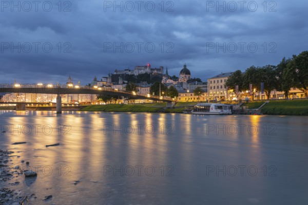 The city of Salzburg with the Salzach shines in the first light of summer morning