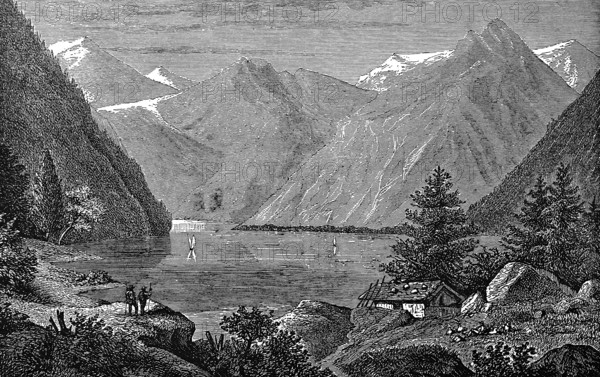 Lake Königsee, idyllic mountain landscape, snow-covered mountains, fir trees, sailing boats, hikers, wooden hut, tourist attraction, Bavaria, Germany, historical illustration 1877
