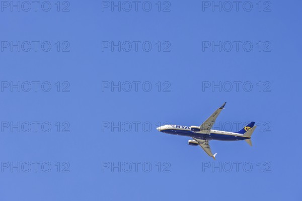 Ryanair passenger plane flying in a blue sky, Mallorca, Spain