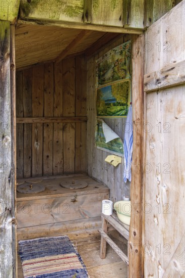 Interior in an old idyllic wooden outhouse for two people in the countryside, Sweden