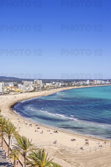 Aerial view at a sand beach with sunbathing tourists by a tourist resort by the sea a sunny summer day, Can Pastilla, Mallorca, Spain