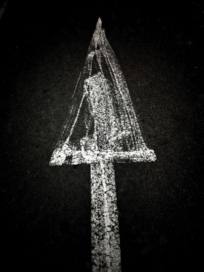 A creative chalk drawing on a dark background depicts a triangular shape with a textured surface surrounding a hidden figure underneath, evoking mystery and intrigue