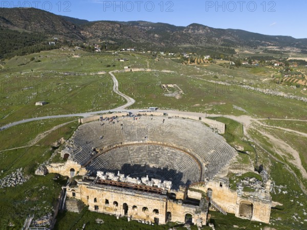 A panorama of an ancient theatre in a vast green landscape, amphitheatre, aerial view, Hierapolis, Pamukkale, Denizli, Anatolia, Turkey