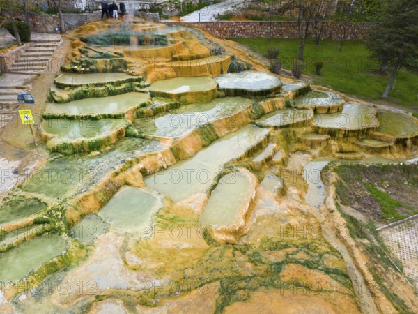 A geothermal landscape with mineral terraces and water accumulations, aerial view, Karahayit Kirmizi Su, Red Spring, Pamukkale, Denizli, Turkey