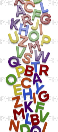 Vertical plastic magnetic letters with drop shadow randomly scattered on surface with drop shadow isolated on a white background