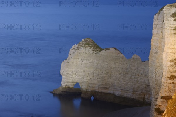 Cliffs with the Porte d'Amont rock gate at dusk, Etretat, Alabaster Coast, Seine-Maritime, Normandy, France