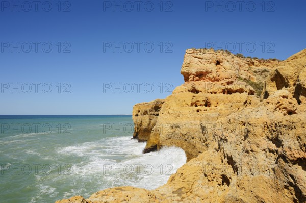 Surf on the rocky coast, Carvoeiro, Algarve, Portugal