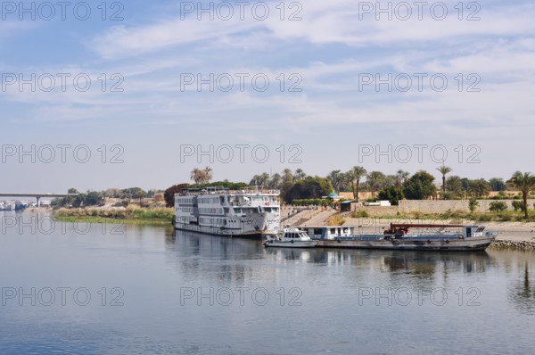 Nile cruise ship and boats at a jetty near Luxor, Egypt