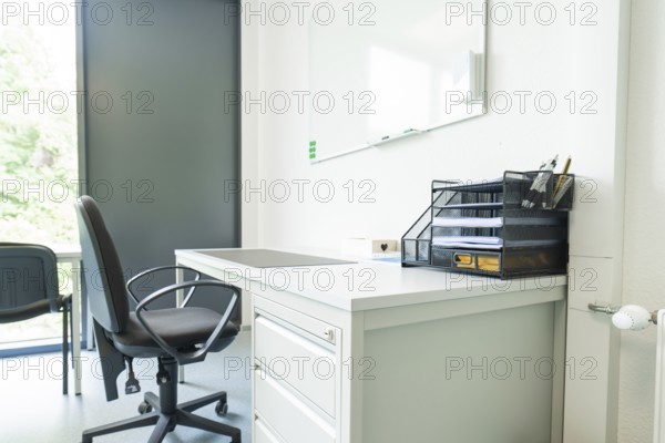 A modern office with desk and chair by the window, Care Connect, vaccination kiosk for refugees, Calw, Germany