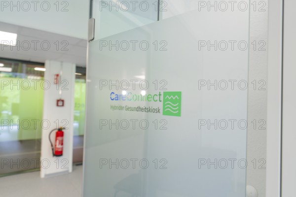 Glass wall with CareConnect logo in a modern office environment, Care Connect, vaccination kiosk for refugees, Calw, Germany