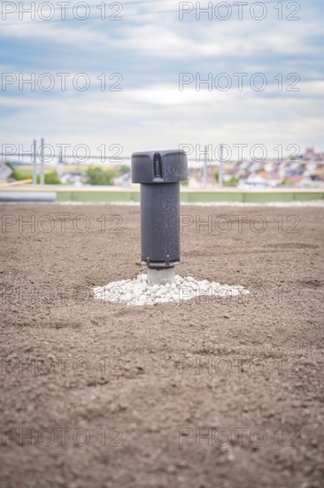 Single ventilation shaft on a green roof with city in the background, green roof, house construction, climate neutral