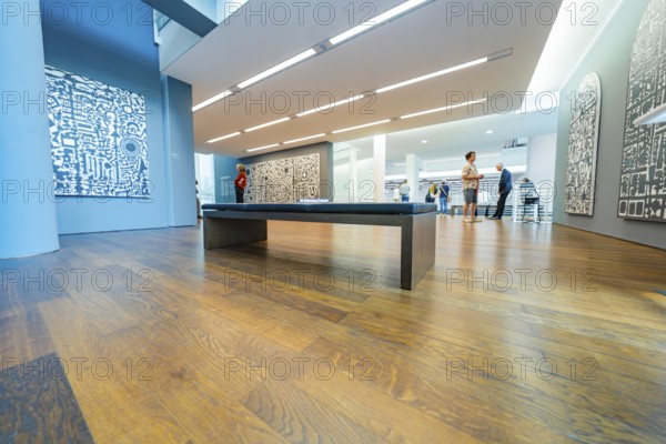 Room with modern architecture and exhibited artworks, animated by visitors, Frieder Burda Museum, Baden Baden, Germany