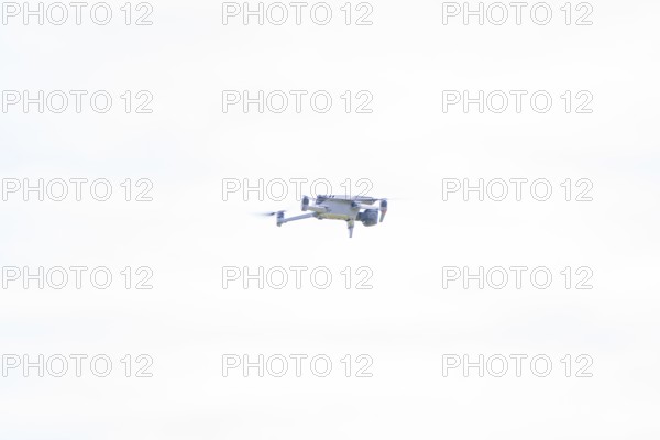 Hovering drone in the bright sky in a minimalist setting, Alpe di Siusi, Dolomites, South Tyrol, Italy