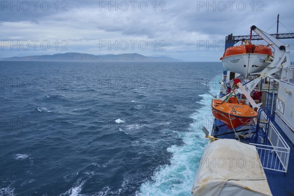 View from a ferry on stormy sea and lifeboats with coastal distance, summer, Cook Strait, North Island, South Island, New Zealand