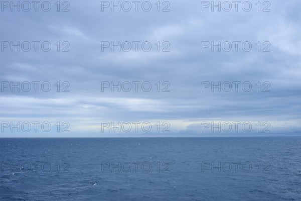 Vast sea under a cloudy sky with a view of distant horizons, summer, Cook Strait, North Island, South Island, New Zealand