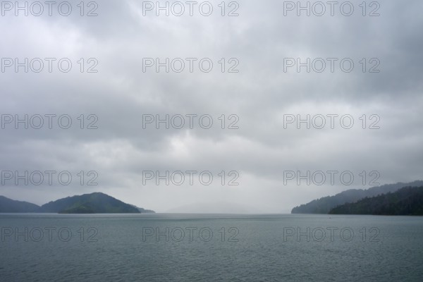 Tranquil landscape with sea and cloudy sky between islands, summer, Cook Strait, North Island, South Island, New Zealand