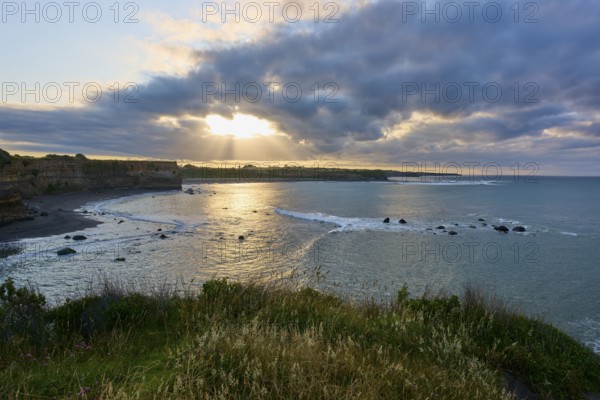 Coastal landscape at sunset with dramatic clouds and undulating sea, summer, Opunake, Taranaki, North Island, New Zealand