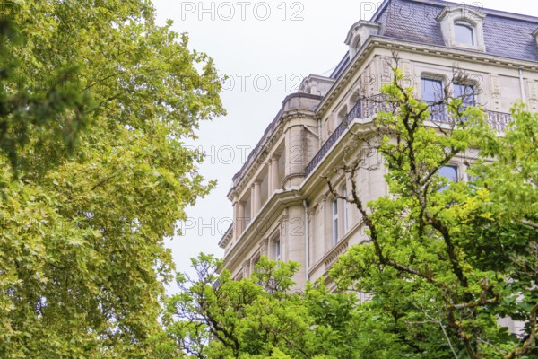 A historic building with an elaborate façade, surrounded by green trees, radiates elegance, Baden Baden, Germany
