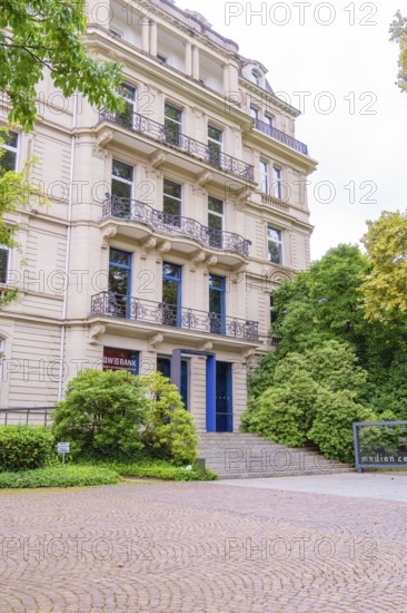 A large classical building with several floors and an exposed entrance, surrounded by trees, Baden Baden, Germany