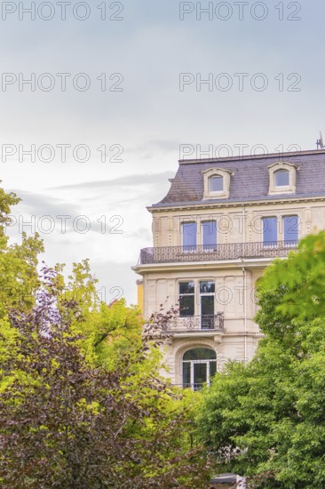 Classic building with richly decorated façade and windows, surrounded by trees, Baden Baden, Germany