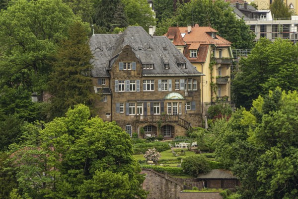 Large manor house surrounded by lush nature and gardens, traditional architectural style, Baden Baden, Germany