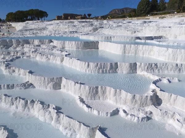 Natural limestone sinter terraces in Pamukkale under a clear sky, aerial view, sinter terraces, limestone sinter terraces, travertine terraces, Pamukkale, Denizli, UNESCO World Heritage Site, Anatolia, Turkey