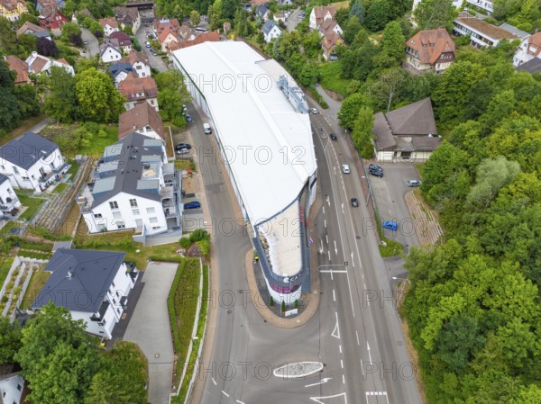 Modern structure in the middle of a green, urban environment photographed from the air, City Centre Calw, Germany