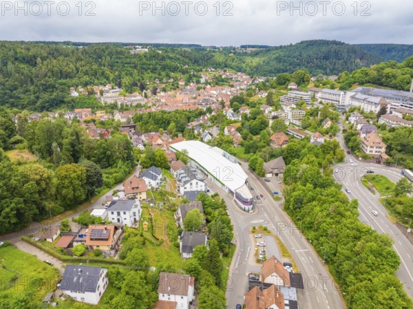 Wide aerial view of an urban landscape with green nature and modern buildings, City Centre Calw, Germany
