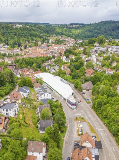 Wide aerial view of an urban area with modern buildings and green hills, City Centre Calw, Germany