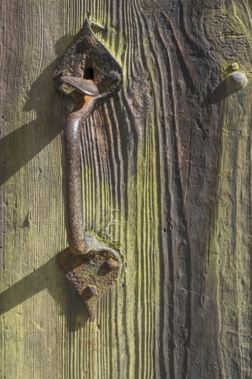 Old wooden door with iron fittings, Münsterland, North Rhine-Westphalia, Germany