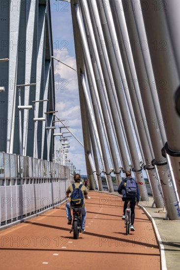 Cycle and pedestrian bridge Snelbinder Brug, over the river Waal near Nijmegen, was added to the existing railway bridge, fast cycle path connection from the city centre of Nijmegen and the new housing estates in the Waalsprong district, Netherlands