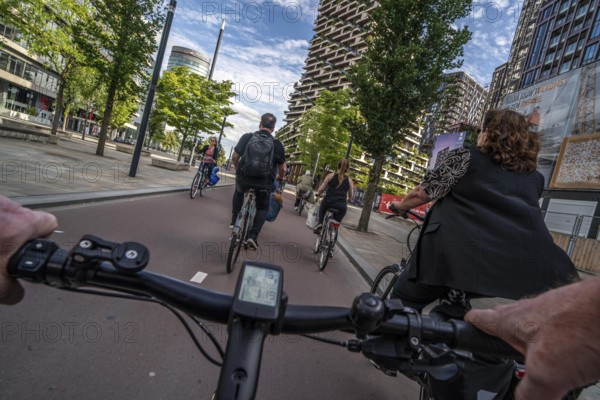 Cycle along the Jaarbeursplein, south of Utrecht Central, HBF, on the central cycle path in the city centre of Utrecht, lanes for pedestrians, cyclists and vehicles are separated, heavy cycle traffic, Netherlands