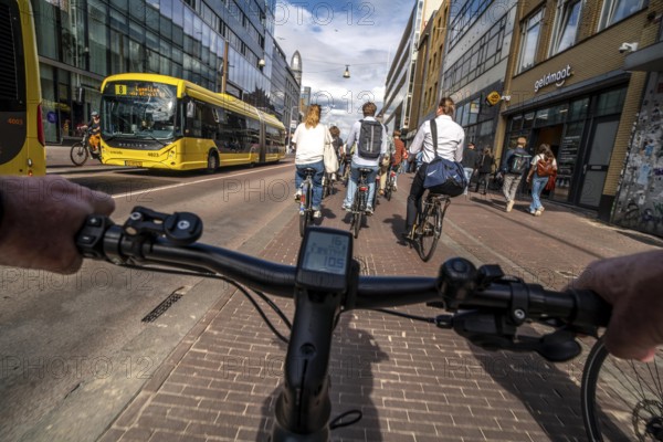 Ride your bike on the central cycle path on Lange Viestraat, Vredenburg, in the city centre of Utrecht, lanes for pedestrians, cyclists and public transport vehicles are separated, heavy cycle traffic, Netherlands