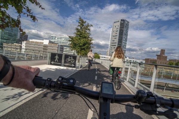 Cycling over the Moreelsebrug, pedestrian and cyclist bridge over the tracks of Utrecht Centraal, Central Station, Rabobank