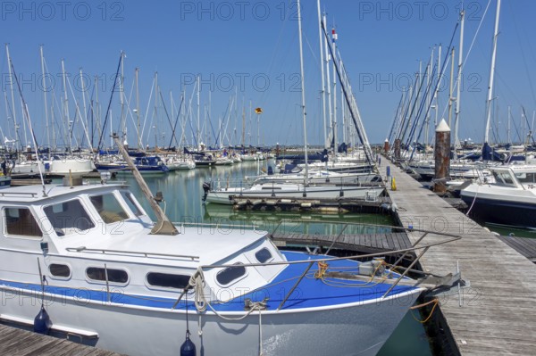 Recreational motorboats and sailing boats moored in marina of fishing village and seaside resort Breskens along Western Scheldt, Zeeland, Netherlands