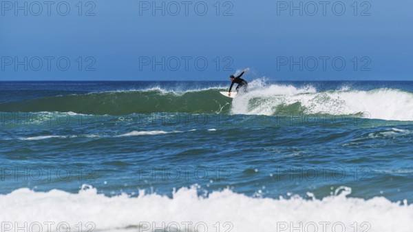 Surfer riding a wave on Contis beach, Saint Julien en Born, Saint-Julien-en-Born, Landes, France