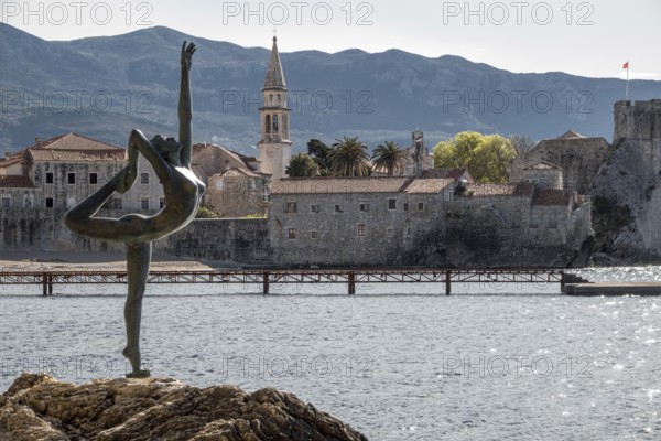 Statue of a ballerina against the background of the old town centre of Budva, Montenegro, Balkans