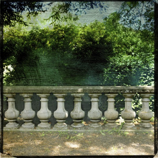 A garden balustrade exhibits a rich textured effect, framed by lush greenery and a captivating view of the Tempest Sea. The scene reflects tranquil nature and classic design. France