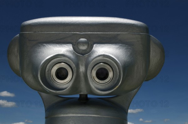 Visitors can easily spot the coin-operated binoculars in Auvergne, France, inviting people to enjoy stunning landscapes and distant vistas on a cloudy day