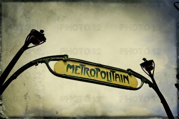 Captured from below, the iconic metro sign in Paris highlights its historic charm and significance as a transportation hub in the bustling Ile de France region, France