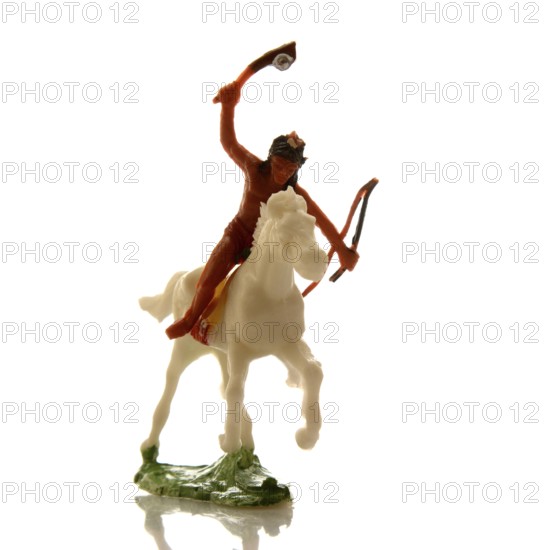 A handcrafted Indian toy soldier is captured riding a white horse with a raised bow and arrow. This colorful figure embodies traditional craftsmanship, ideal for collectors or children