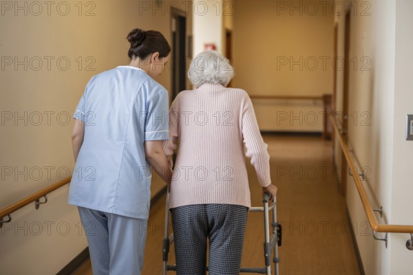 Female nurse helping older woman walk with walker in rehabilitation center hallway. Elder care and nursing support. Generative ai, AI generated