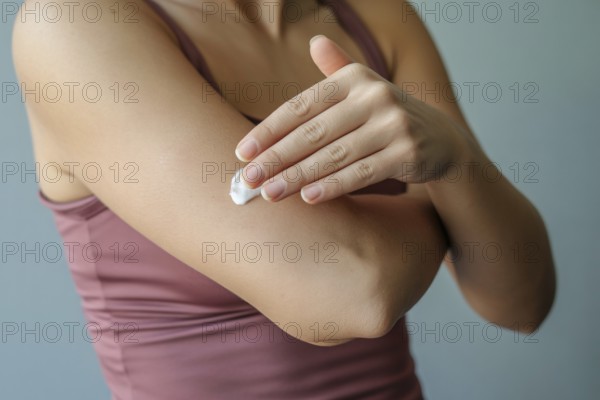 Woman applying moisturizing cream to arm. Concept for skincare and self-care routine. Generative ai, AI generated