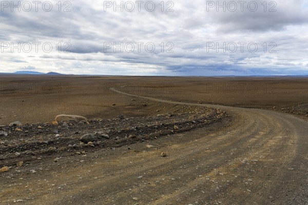 Highland road F-35, gravel track Kjalvegur Kjölur leads through barren stony volcanic landscape, desert, lava field, plateau, Icelandic highlands, Suðurland, Sudurland, Iceland