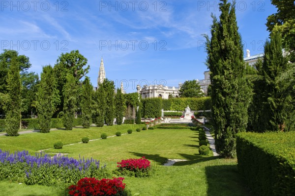 Vienna Volksgarten with a view of the famous Sisi Monument with the Town Hall Tower and the Burgtheater in the background, Vienna, Austria
