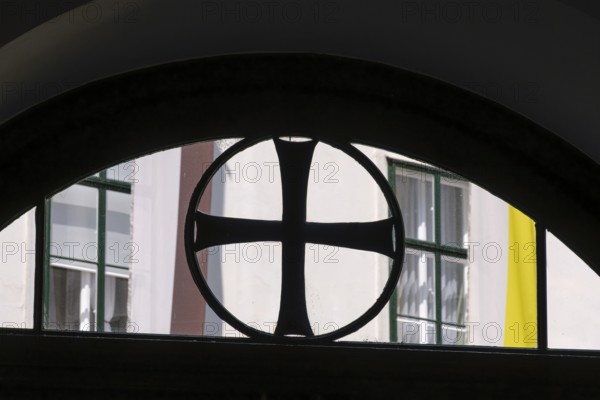 Black paw cross in the skylight of the entrance to the Deutschordenshaus in Vienna, Austria, for editorial use only