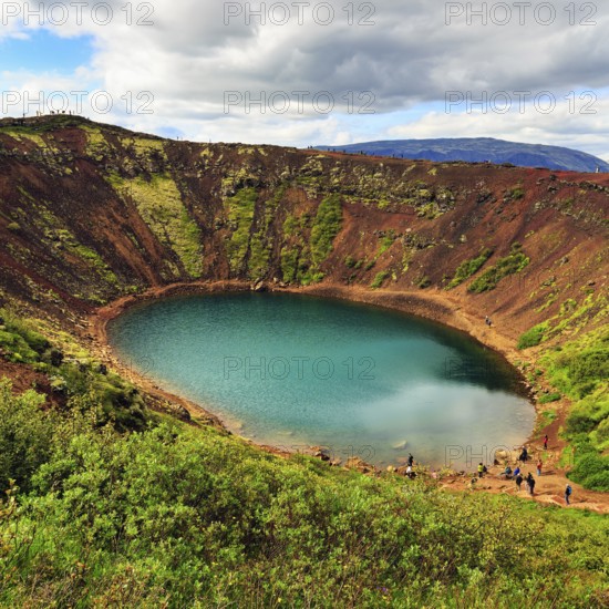 Hikers round Kerið, Kerid, crater lake with turquoise-green water, Golden Circle, ring road, Iceland