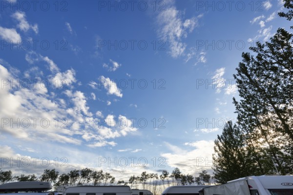 Cumulus, roofs of caravans and motorhomes on a campsite in the evening, Suðurland, Sudurland, Iceland