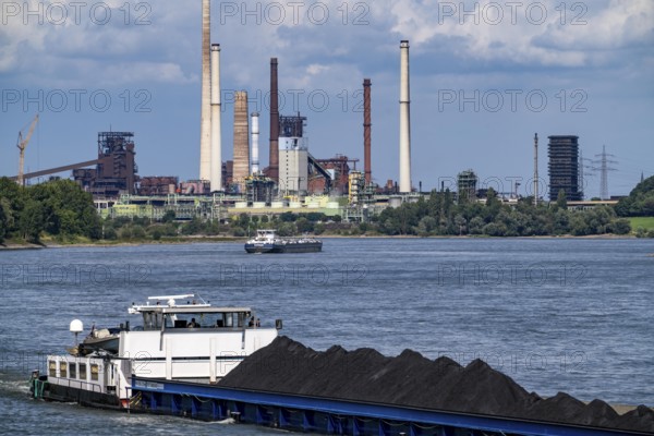Industrial scenery of the ThyssenKrupp Steel steelworks in Duisburg-Bruckhausen, cargo ships on the Rhine, freighter Anja I, loaded with coal, blast furnaces, coking plant Schwelgern, Duisburg, North Rhine-Westphalia, Germany
