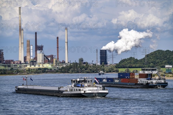 Industrial backdrop of the ThyssenKrupp Steel steelworks in Duisburg-Bruckhausen, cargo ships on the Rhine, blast furnaces, Schwelgern coking plant, extinguishing cloud, Duisburg, North Rhine-Westphalia, Germany